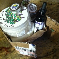 a colorful package from Good 4 You Herbals with mint scrub, cleavers tincture, yarrow balm, and apricot shimmer salve!